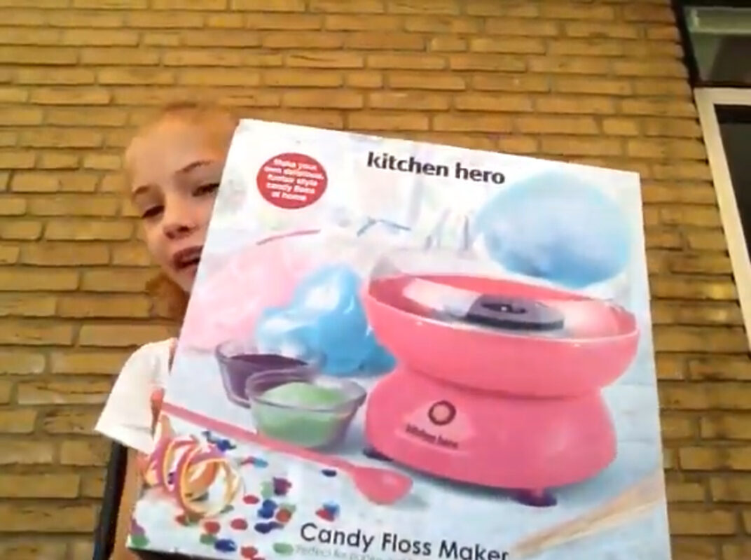 Meisje met suikerspinmachine verpakking, opgenomen voor een YouTube video.